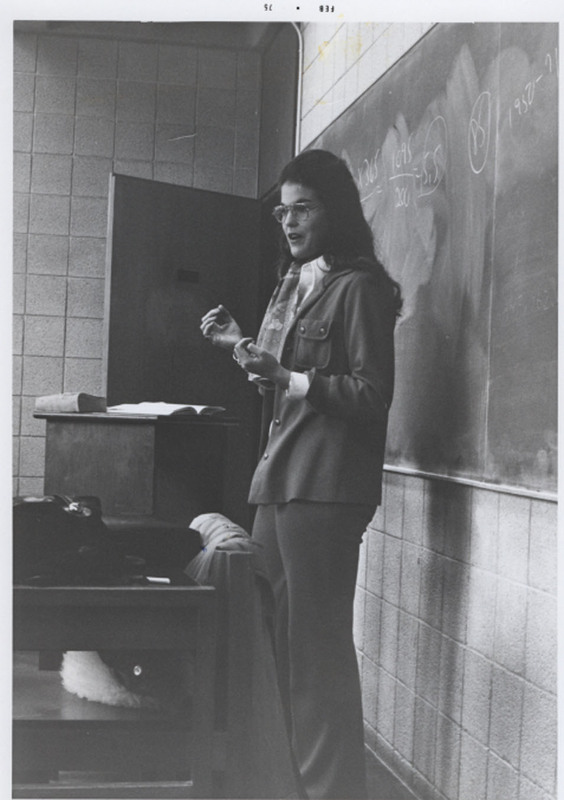 Jane Lunin Perel teaching in front of a chalkboard.