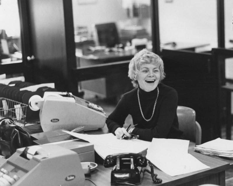 Margaret O'Donnell sitting at an office desk next to a printing calculator.