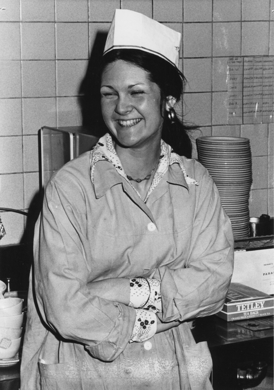 Mary Anne Frieson standing in a kitchen with a dining services uniform on.