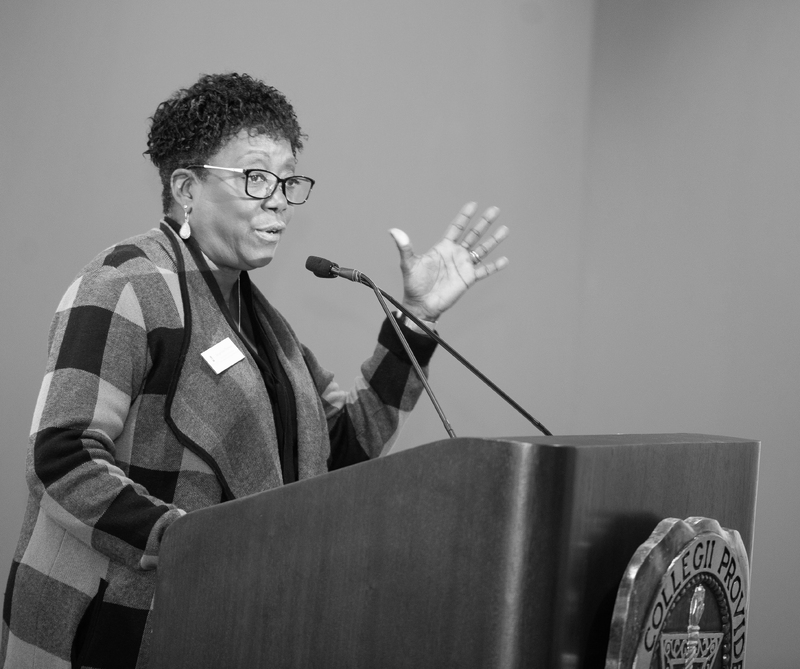 Jackie Peterson standing at a podium giving a speech.
