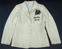 A Friars Club white jacket with a black and white checkered pocket square. The words 'Friars Club' and a key are embroidered on the front pocket.