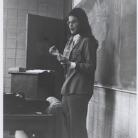 Jane Lunin Perel teaching in front of a chalkboard.