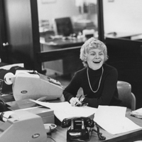 Margaret O'Donnell sitting at an office desk next to a printing calculator.