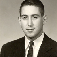 Portrait of Howard Lipsey wearing a suit and tie in front of a light background.