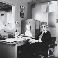 Helen Bert sits at a desk in an office.