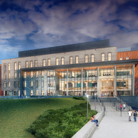 Rendered image of modern multi-story building with glass, brick, and stone exterior, surrounded by trees and lawn, with people sitting on benches along a wide staircase under a partly cloudy sunset sky.
