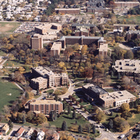 Aerial view of Providence College with academic buildings, dormitories, sports fields, and surrounding residential neighborhoods.